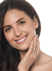 Fototapeta premium Beautiful woman face healthy clean skin spa cosmetic concept isolated on white healthy teeth smile