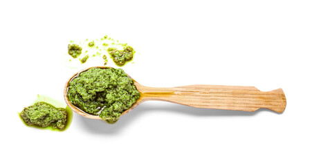 Spoon with fresh pesto sauce on white background
