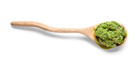 Spoon with fresh pesto sauce on white background