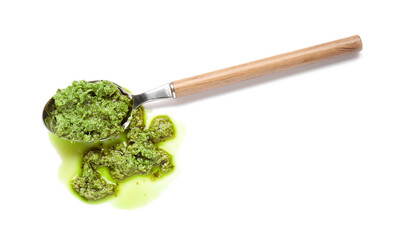 Spoon with fresh pesto sauce on white background