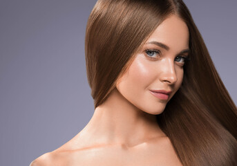 Fototapeta premium Beautiful woman with long beautiful smooth hair natural make up healthy skin
