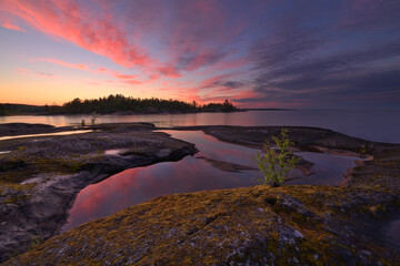 Stone shore of Lake Ladoga on a summer evening