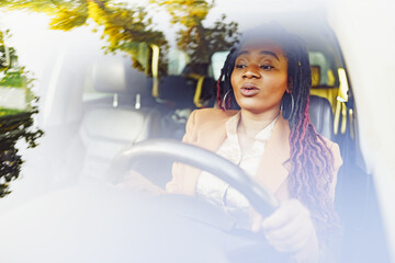 Emotional black woman sitting in a car