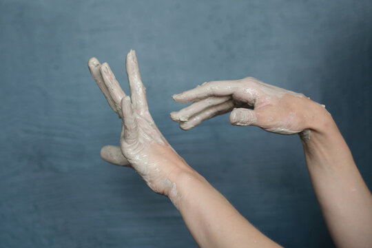 female hands clotted mud clay play cheerfully and show hands. Hands dirty - Powered by Adobe