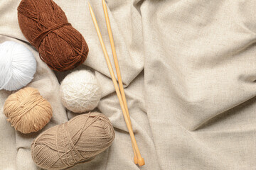 Fototapeta na wymiar Knitting yarn and needles on fabric background