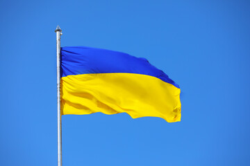 Waving national flag of Ukraine outdoors