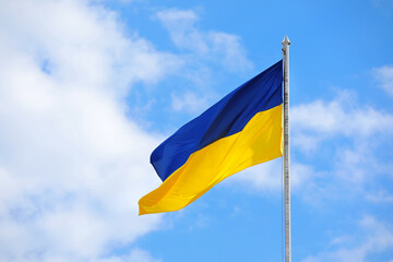 Waving national flag of Ukraine outdoors