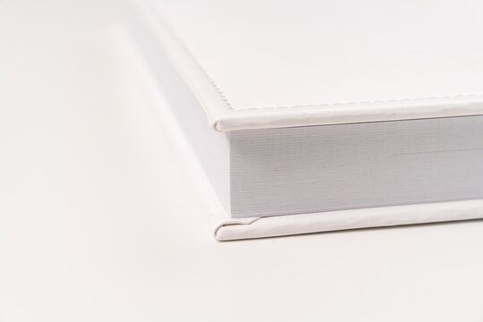 close-up of thick plastic pages white book in leather binding. photobooks.