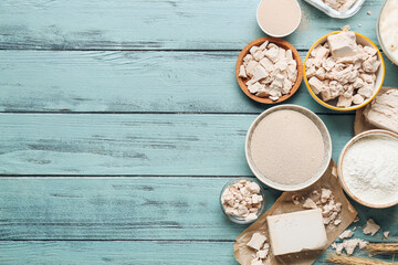 Composition with fresh and dry yeast on color wooden background