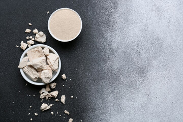 Bowls with fresh and dry yeast on black and white background