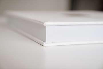 close-up of thick plastic pages white book in leather binding. photobooks.