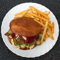 Tasty grilled beef burger with french fries. Fast food. Top view