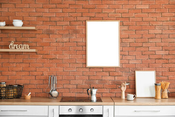 Interior of modern kitchen with blank photo frames