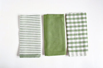 Top view new kitchen towels in verdun green ,strip and white color simple pattern in differnet style on white background .Equipment necessary  in kithchen for wippe things.