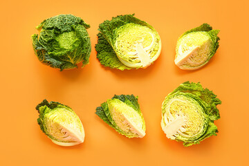 Pieces of fresh savoy cabbage on color background