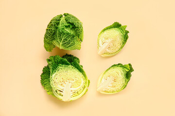 Pieces of fresh savoy cabbage on color background