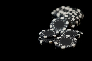 Stack of Casino gambling chips isolated on black reflective background