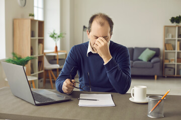 Senior business man who is tired from the workload suffers from headaches and lack of sleep....