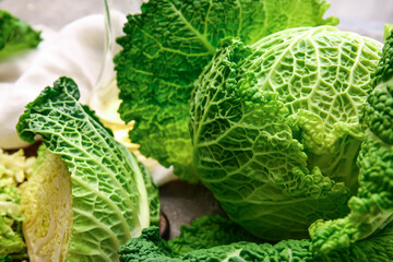 Fresh savoy cabbage on grunge background, closeup