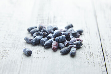 Honeysuckle berries on grey wooden table
