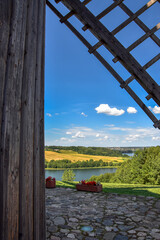 Wooden windmill wing, beautiful lake landscape in the background