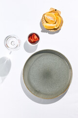 Top view of restaurant or cafe table with white tablecloth. Empty cafe table with sunshine and harsh shadow view from above. Summer day at cafe concept. Crystal white background.