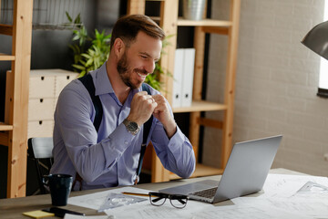 Smiling young Caucasian man designer or architect making video call.