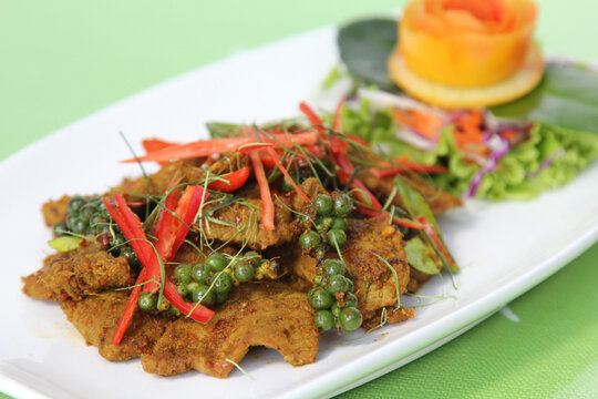 Stir fried cartilage pork with spicy curry paste (Thai call *Kua Kling*) thai food, in white dish