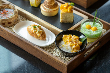 Many kinds of sweets made from mango, sweet thai dessert cuisine made from sticky rice, mango, coconut, Sliced mango with sweet and salty sauce that made of tiny shrimp with fish sauce and sugar, 
