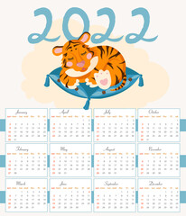 calendar design for 2022 featuring a tiger cub sleeping on a pillow.
concept of New Year 2022 according to the Chinese calendar. Year of the tiger.
Children's cute character orange tiger.