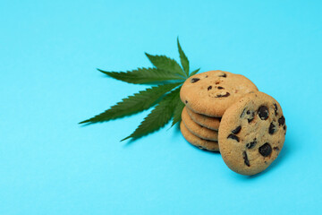 Cannabis cookies and leaf on blue background