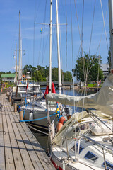 Sailboats moored at a jetty in Göta canal at Sweden