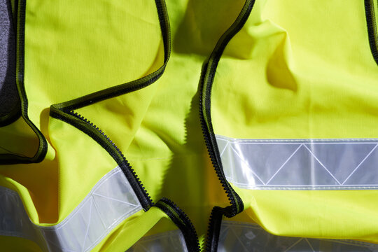 close up of yellow color safety vest with silver reflector