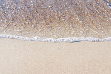 Soft wave of the sea on the sandy beach.Soft focus,blurred image.