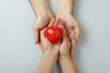 Donor concept with hands holding red heart on white background
