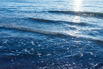 Deep blue and rough sea with lot of sea spray.Blue background.Soft focus.