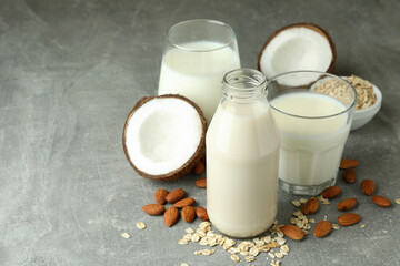 Concept of vegan milk on gray textured background
