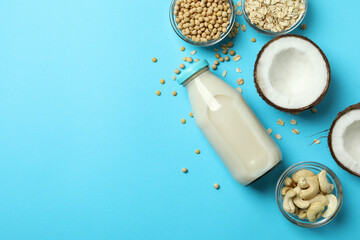 Concept of vegan milk on blue background, top view