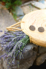 Straw bag filled with fresh lavender flowers and retro sunglasses. Selective focus.