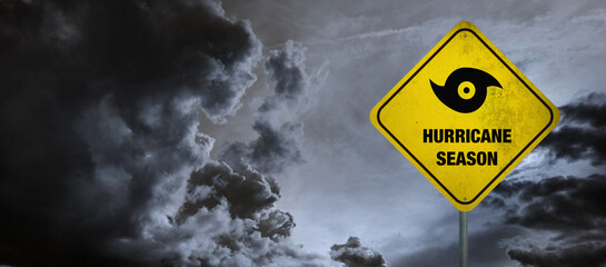 Hurricane season banner with storm clouds background.