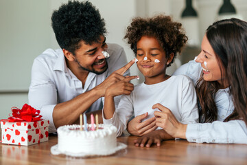 Happy family celebrating a birthday together at home