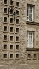 Fototapeta na wymiar traditional wall street light on a stone wall, Saint Malo, France