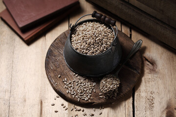 sunflower seeds in cup on the wooden background