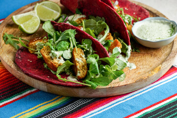 Mexican national food - taco wheat beetroot tortilla with vegan chickpea balls and vegetables