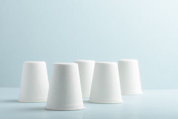 Biodegradable paper cup on blue background. Eco-friendly sustainable products concept zero waste lifestyle. Minimalism simple and copy space