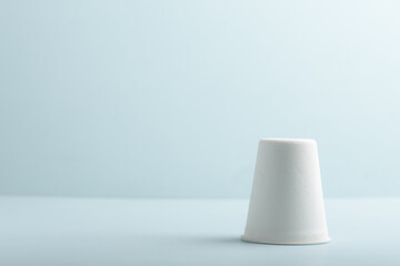 Biodegradable paper cup on blue background. Eco-friendly sustainable products concept zero waste lifestyle. Minimalism simple and copy space