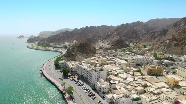 Muscat, Oman: Aerial view of capital city of sultanate on Arabian Peninsula, clear blue sky and emerald waters of Arabian Sea - landscape panorama of Middle East from above
