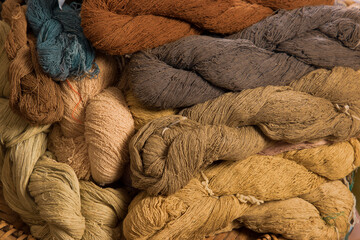 traditional handmade cotton thread from natural dye color with earth tone colour group background