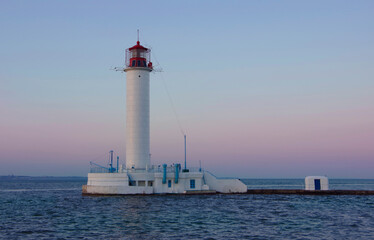 Odessa, Ukraine, 06.21.20. View of the lighthouse against the backdrop of the sunset.