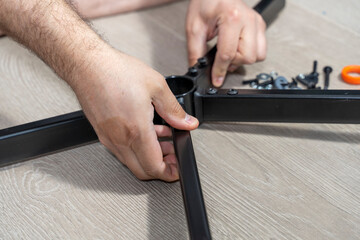 a man assembles a new chair at home